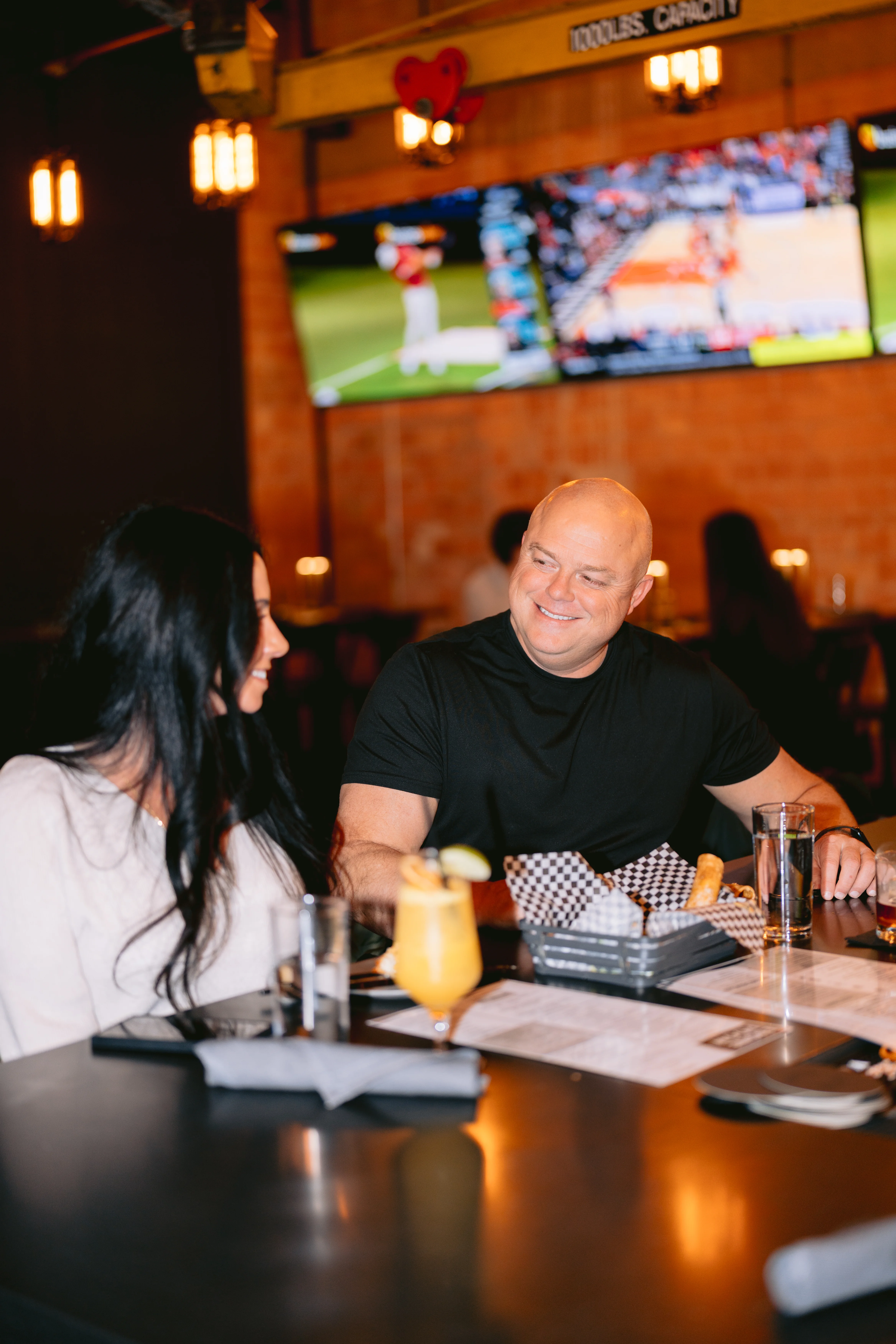 Couple enjoying drinks and food at a restaurant