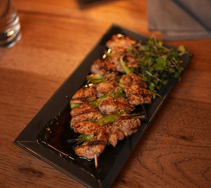 Grilled chicken skewers with herbs and sauce